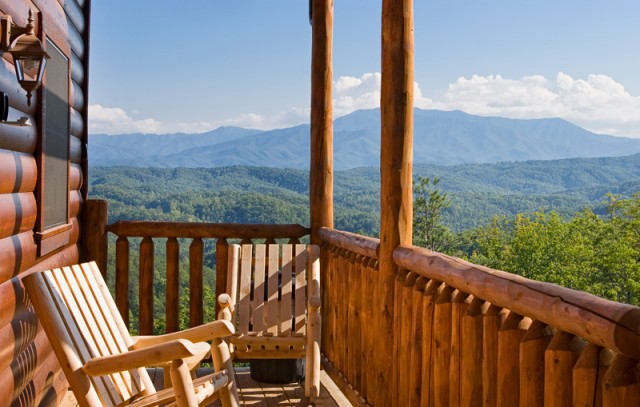 Deck chairs offer a log cabin view of the Smoky Mountains